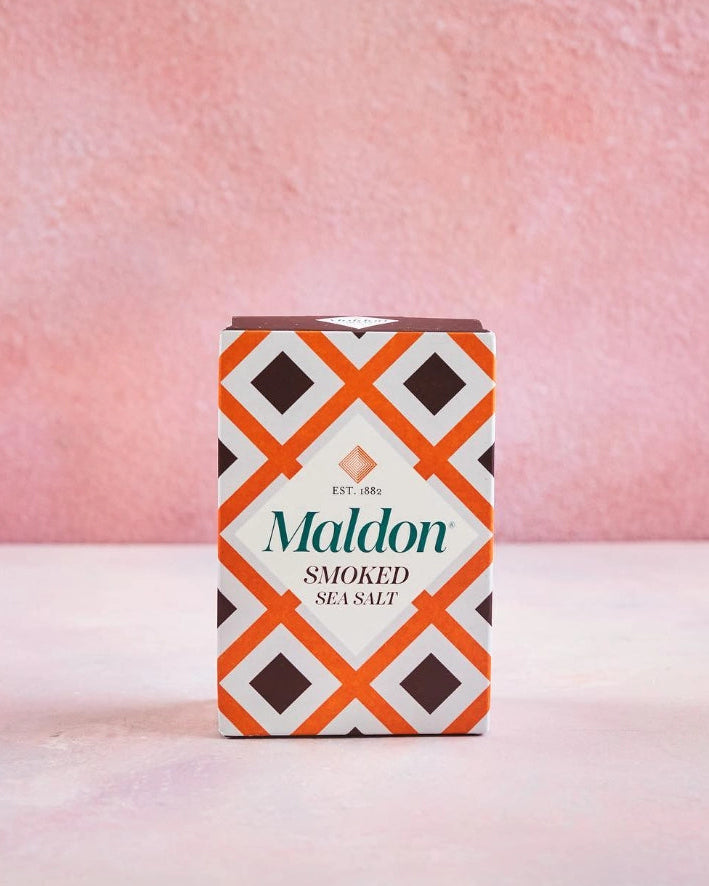 Maldon smoked sea salt packaging with a geometric pattern on a pink background