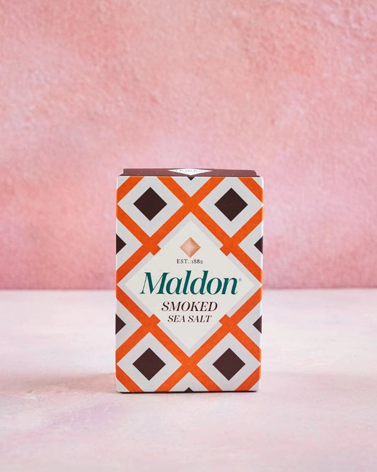 Maldon smoked sea salt packaging with a geometric pattern on a pink background