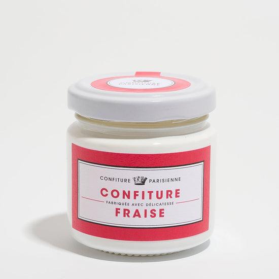 A jar of strawberry jam with a red and white label on a white background