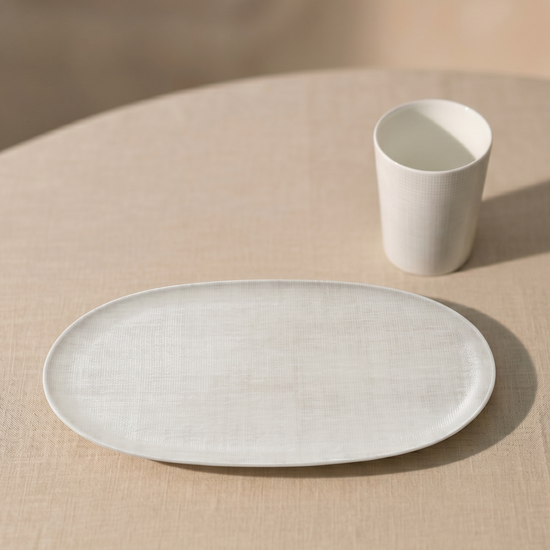 Ceramic plate and cup on a beige tablecloth
