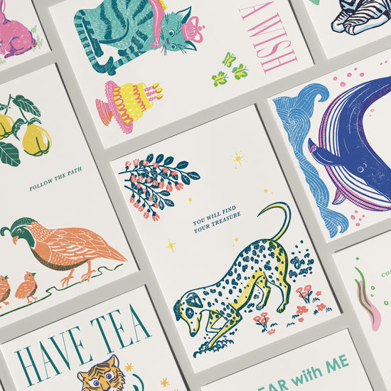 Collection of colorful greeting cards with various illustrations and text.
