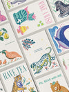 Collection of colorful greeting cards with various illustrations and text.