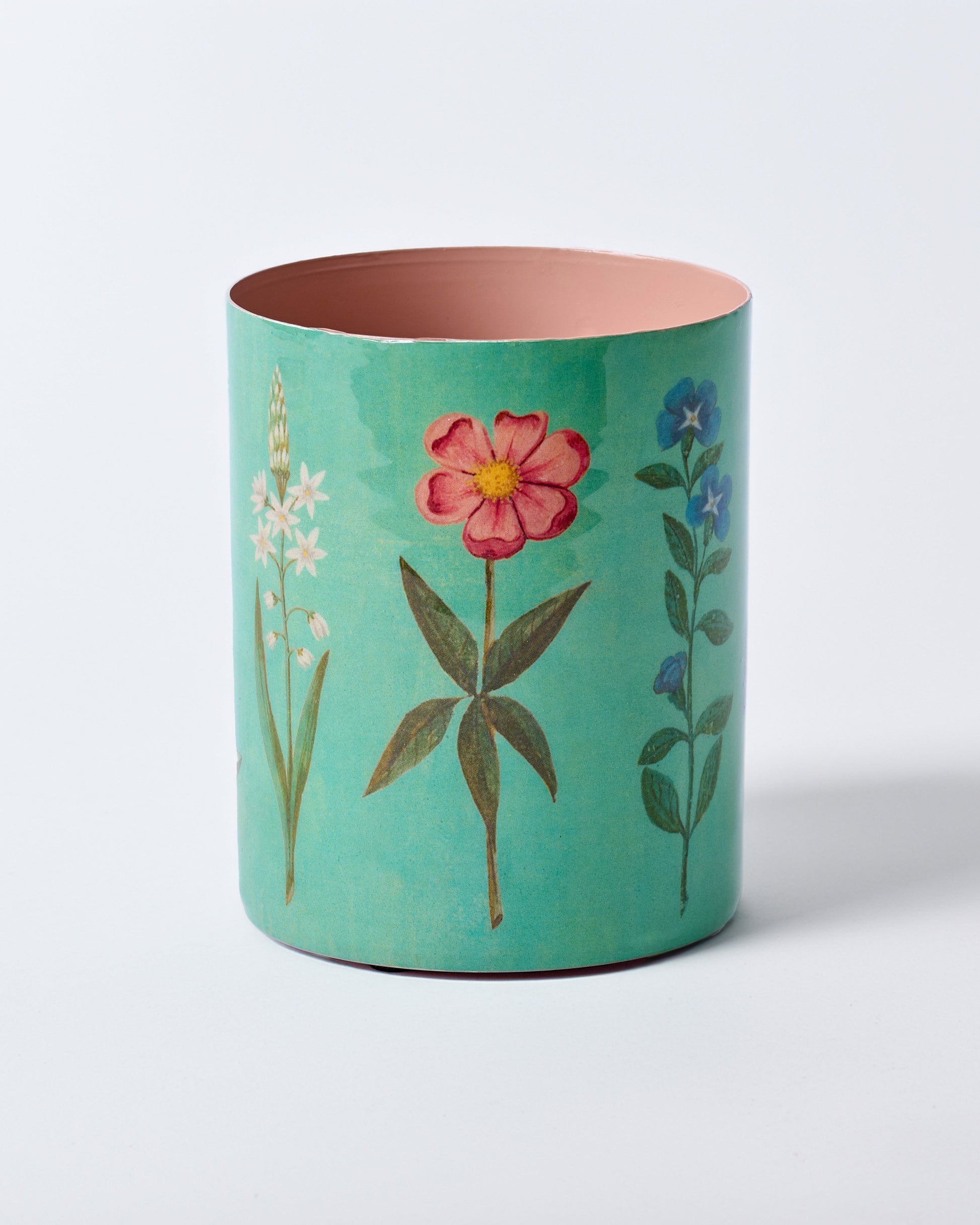 Teal cylindrical container with floral designs on a white background