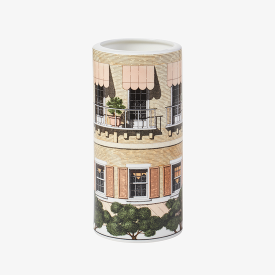 Cylindrical vase with architectural design on a white background
