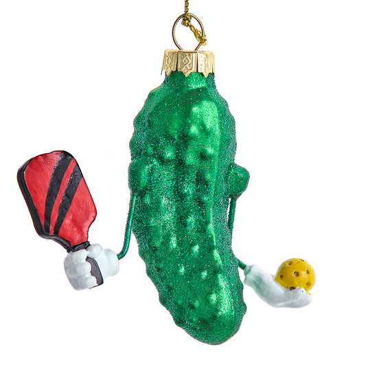 Green pickle ornament with pingpong ball on a white background