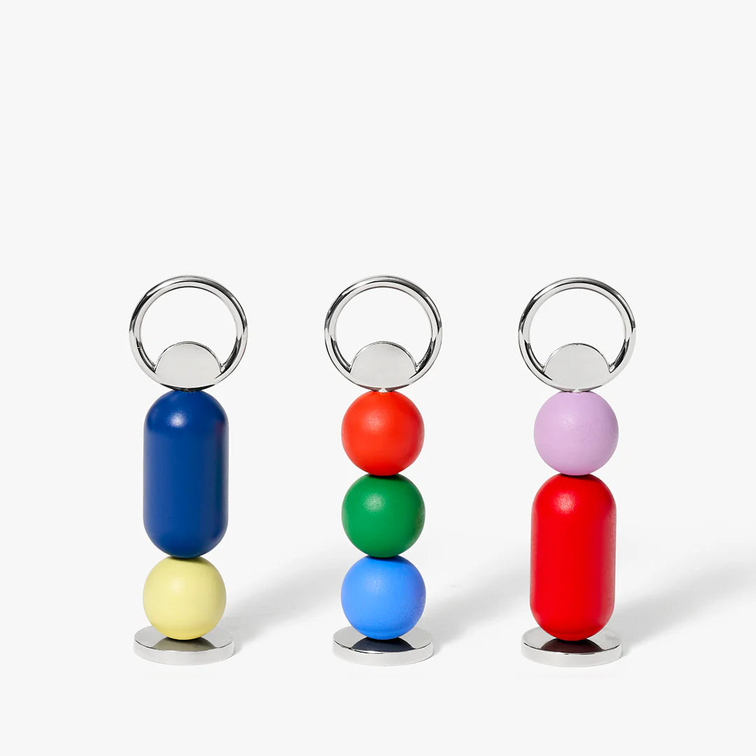 Three colorful bottle opener with cylindrical and spherical beads on a white background