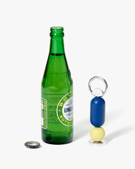 Green bottle with a bottle opener keychain on a white background