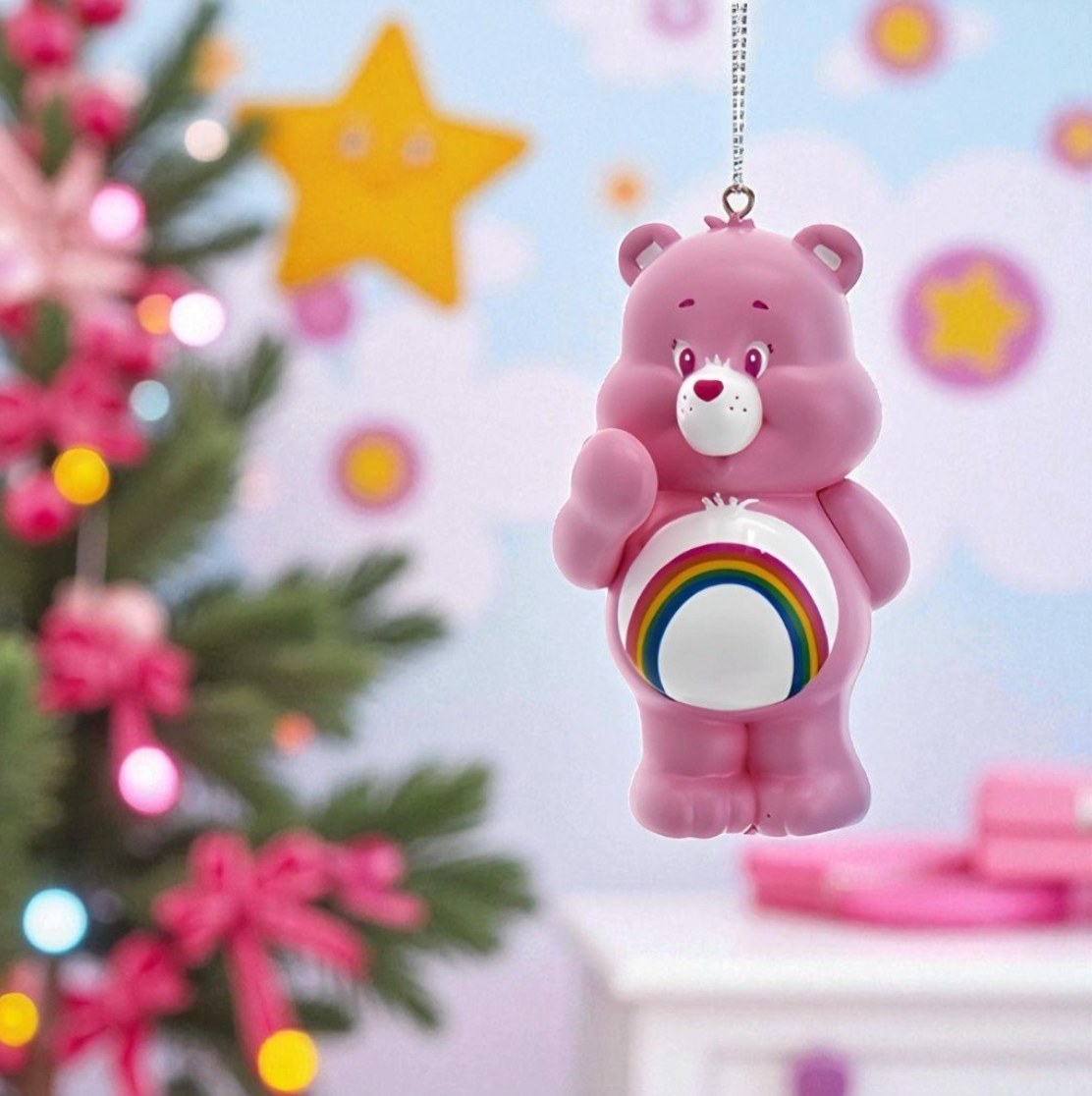 Pink bear ornament with rainbow design on a blurred festive background
