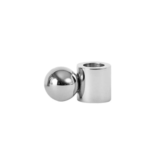 Silver cylindrical and spherical metal candle holder on a white background