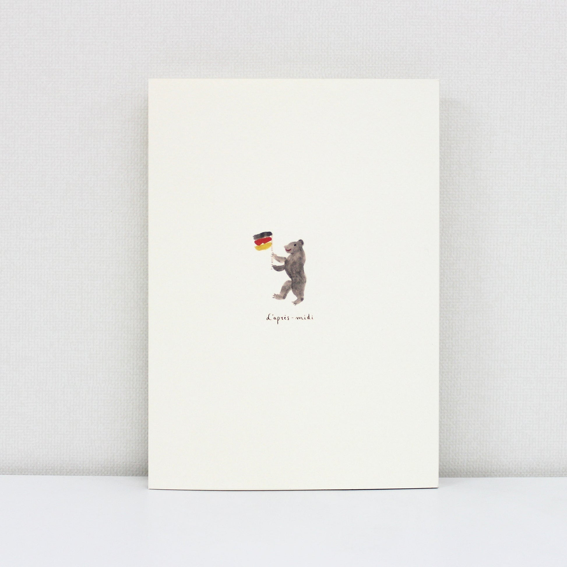 Notebook with a bear holding a German flag on a white background