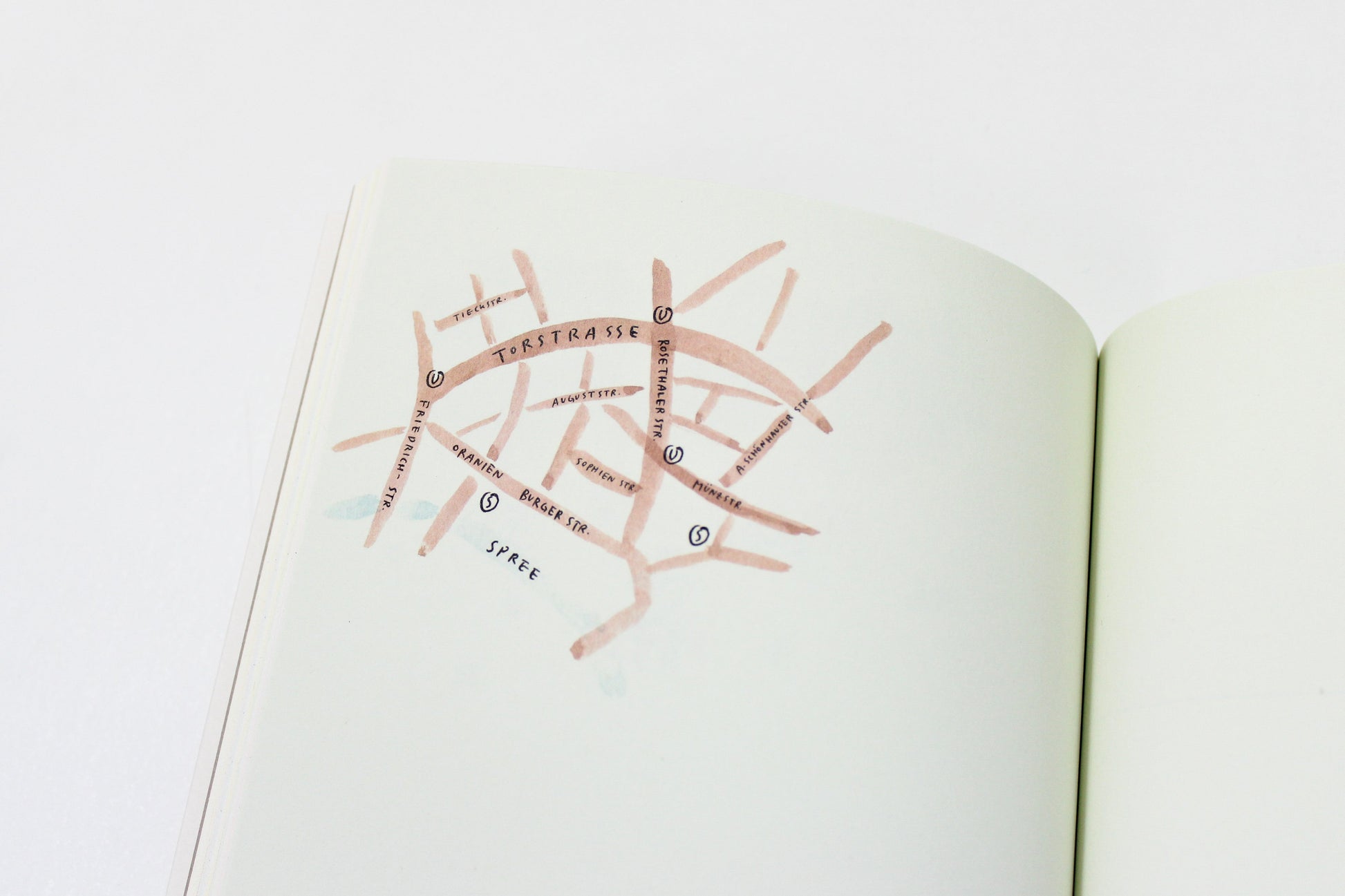 Open book with a map of a city on a white background
