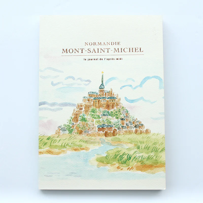 Notebook with illustration of Mont-Saint-Michel on a light blue background