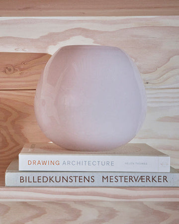 Decorative lamp on books with a wooden surface background