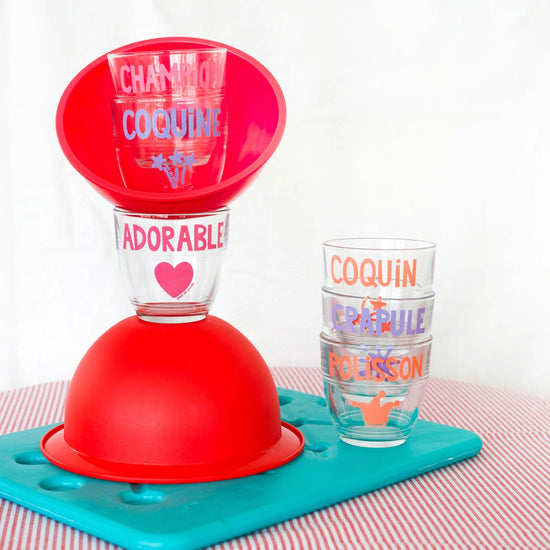 Red plastic stand with colorful cups on a white background