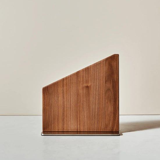 Wooden magnetic knife stand with a geometric design on a neutral background