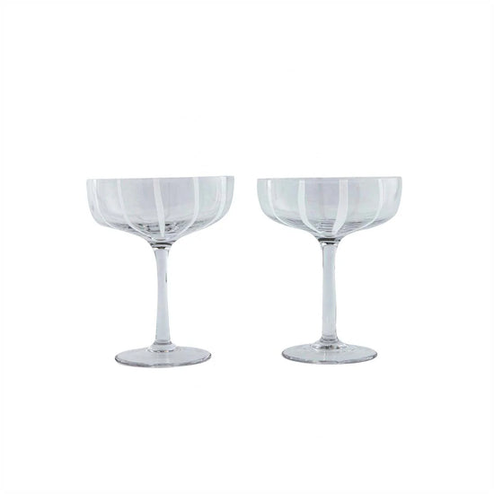 Two clear glasses with decorative patterns on a white background