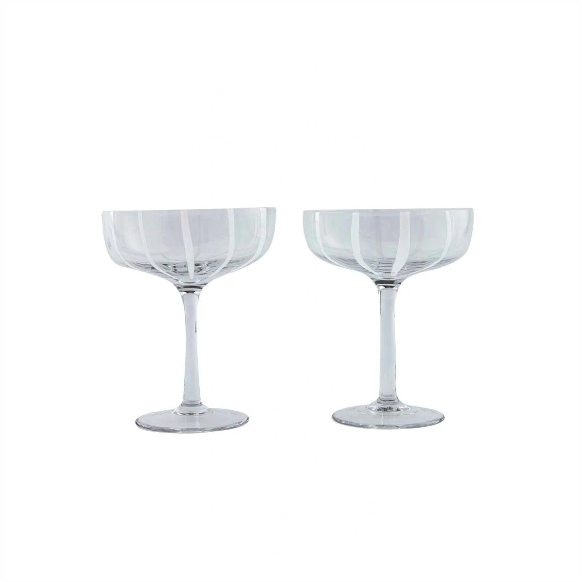 Two clear glasses with decorative patterns on a white background