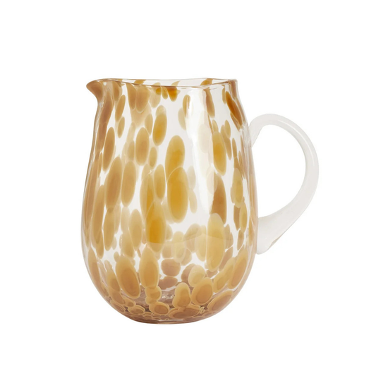 Glass mug with brown and white abstract pattern on a white background