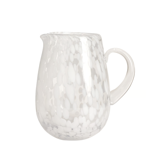 White ceramic pitcher with a textured surface on a white background