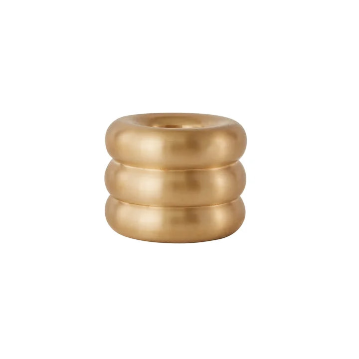 Gold candle holder with ribbed design on a white background