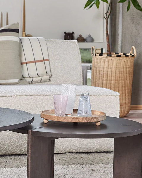 Living room with a beige sofa, coffee table, and decorative items.