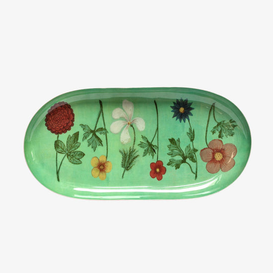 Green oval tray with floral designs on a white background