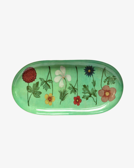 Green oval tray with floral designs on a white background
