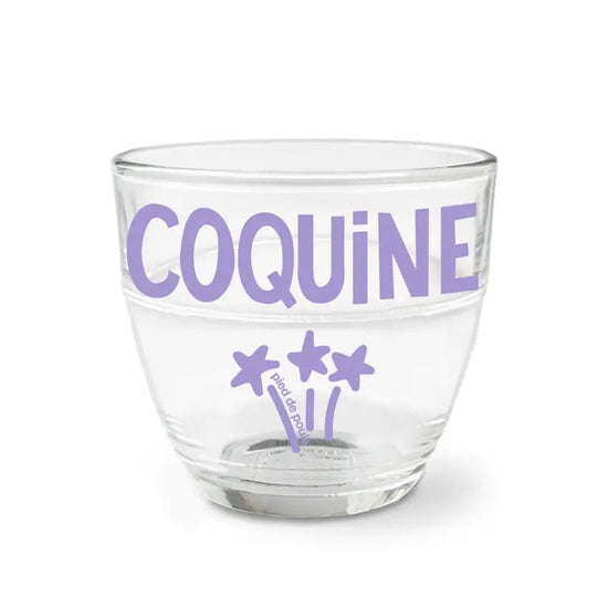 Clear glass with purple text and star designs on a white background