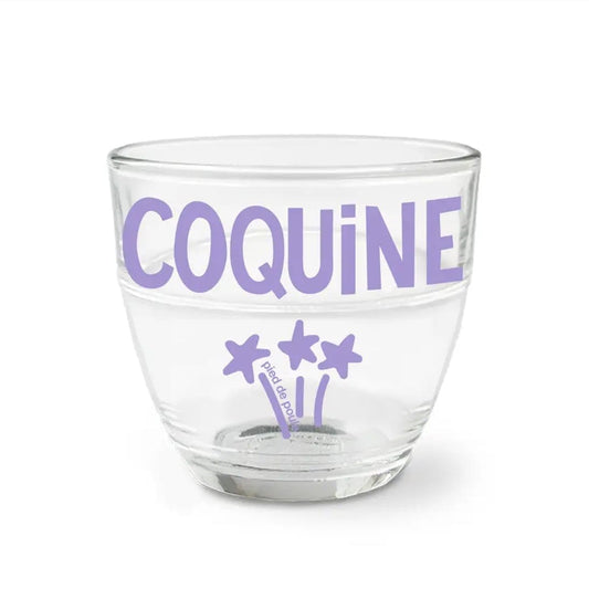 Clear glass with purple text and star designs on a white background
