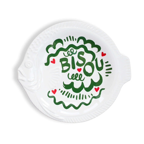 Round white dinner plate with green text and red hearts on a white background