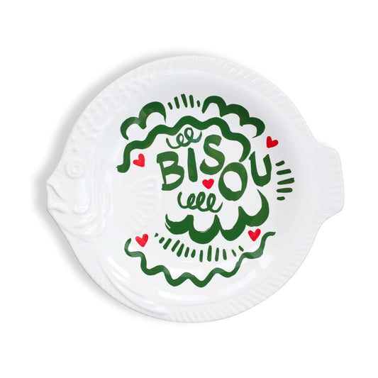 Round white dinner plate with green text and red hearts on a white background