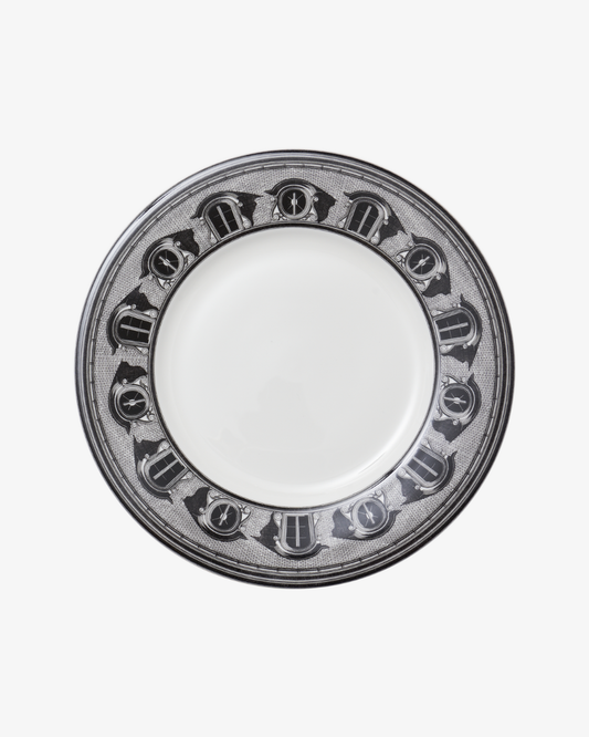 White plate with decorative black rim on a white background