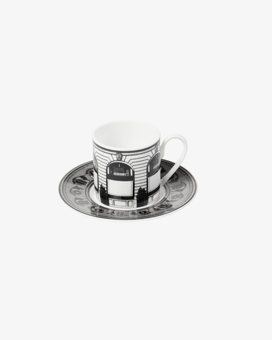 Ceramic cup and saucer with black and white design on a white background