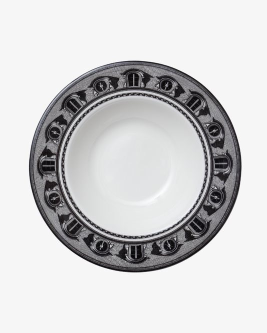 White ceramic bowl with decorative black rim on a white background