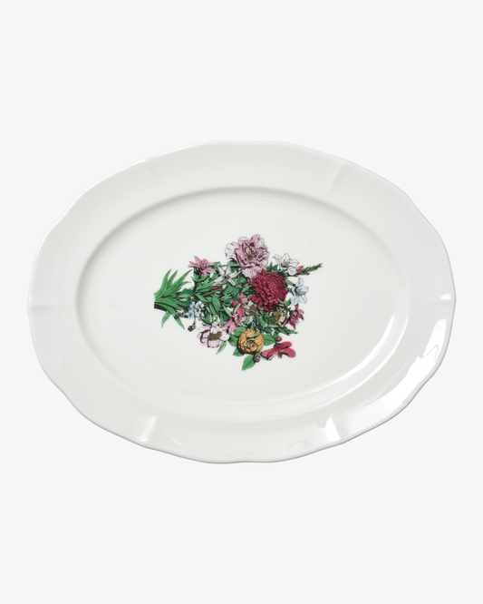 White oval plate with floral design on a white background