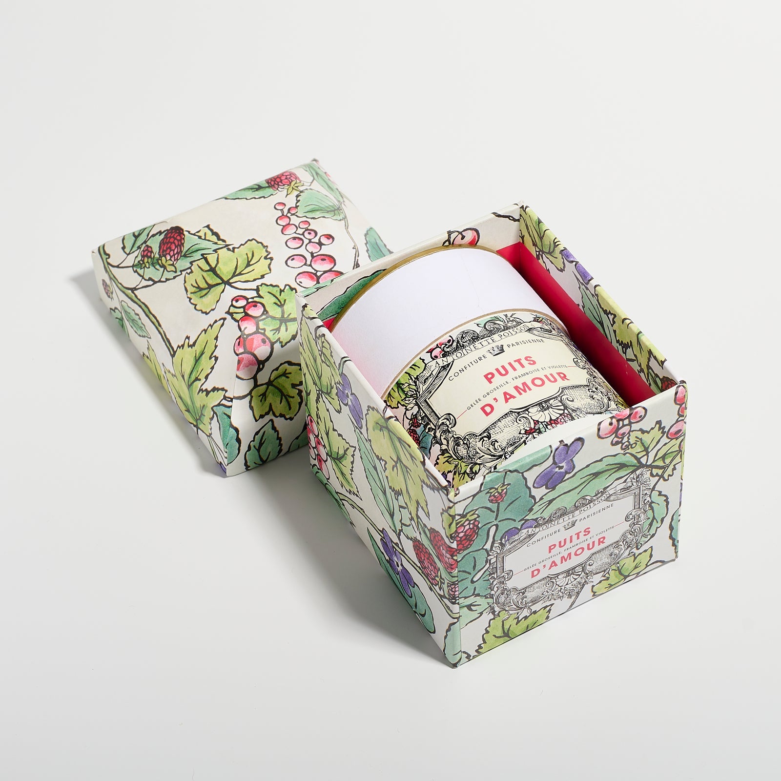A jar packaged inside a floral illustrated box with the lid placed beside it