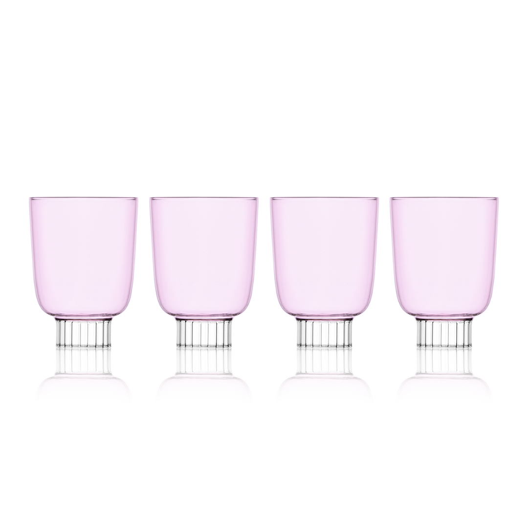 Four pink wine glasses with silver bases on a white background