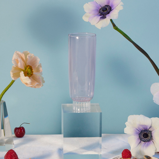 Pink Champagne glasses in pink on blue background with flowers