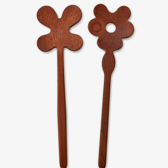 Two wooden hair sticks with floral designs on a white background