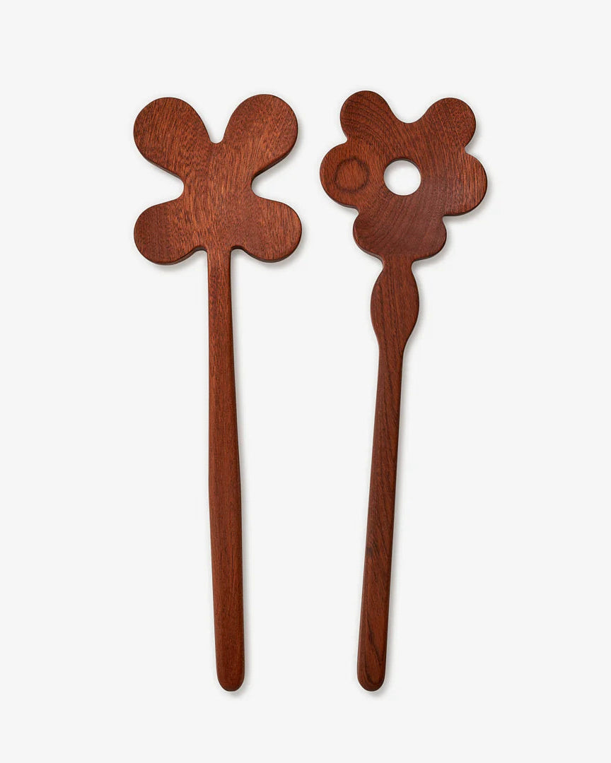 Two wooden hair sticks with floral designs on a white background