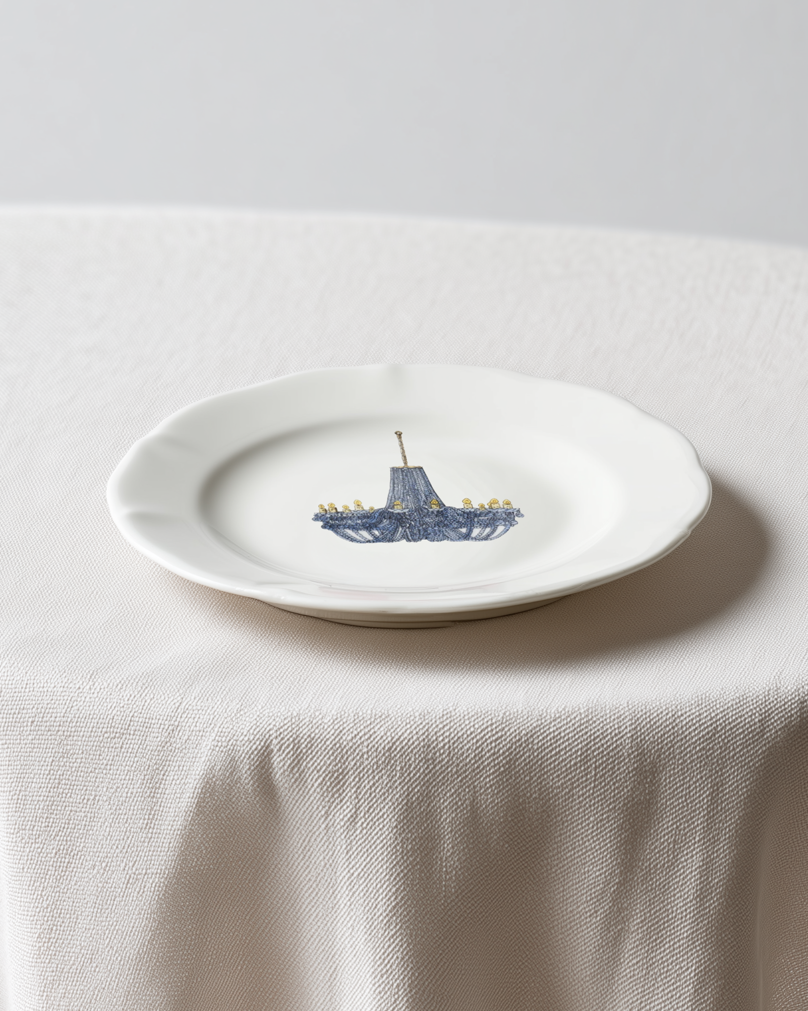 White plate with a blue ship design on a white tablecloth