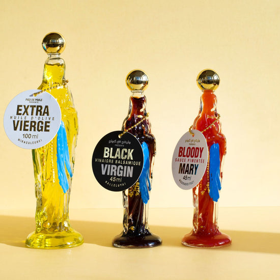 Three bottle-shaped drink dispensers with labels on a beige background