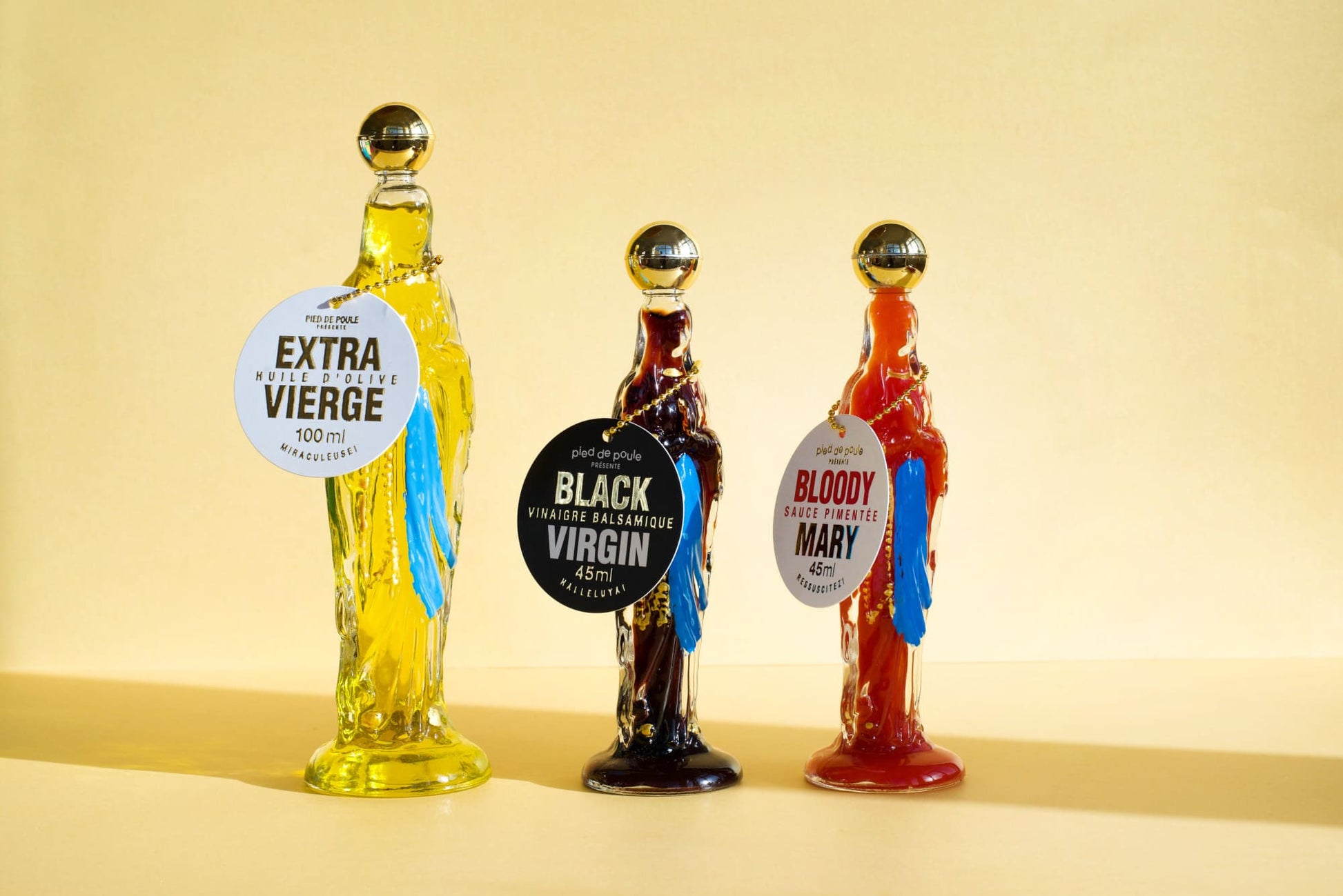 Three bottle-shaped drink dispensers with labels on a beige background