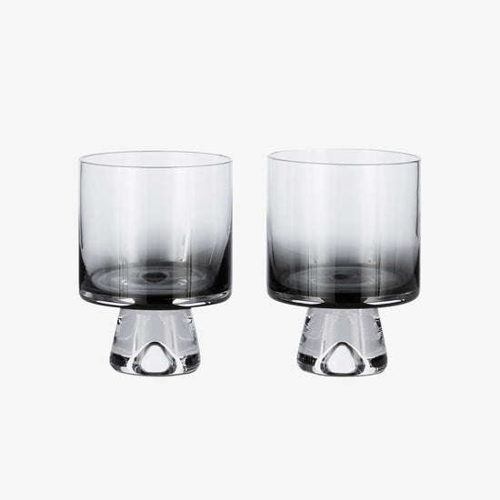 Two glass tumblers with a gradient design on a white background