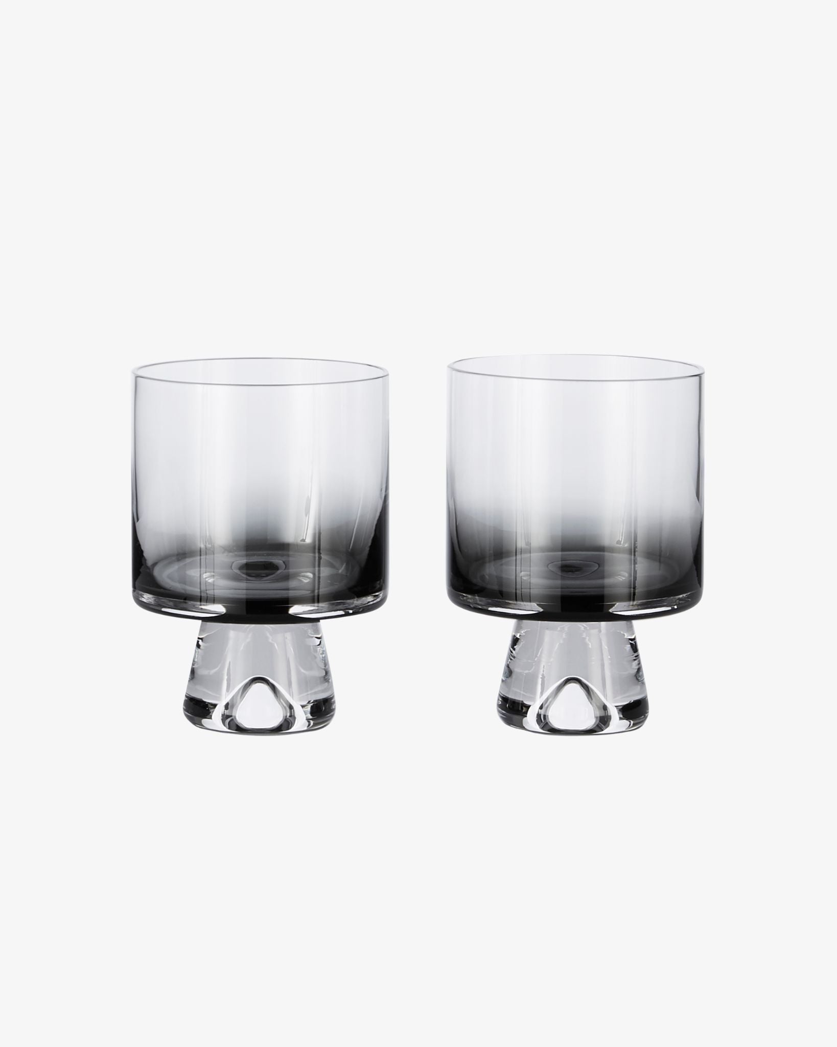 Two glass tumblers with a gradient design on a white background