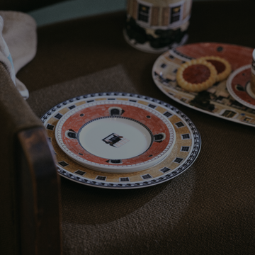 Decorative ceramic plate with intricate design on a textured surface