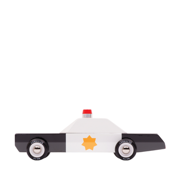 a black and white wooden toy police car with a yellow star badge graphic and a small red siren on a white background