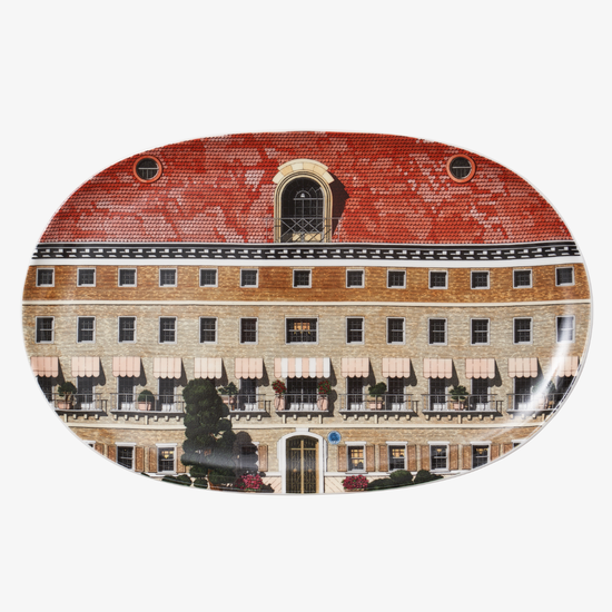 Decorative plate with a building design on a white background