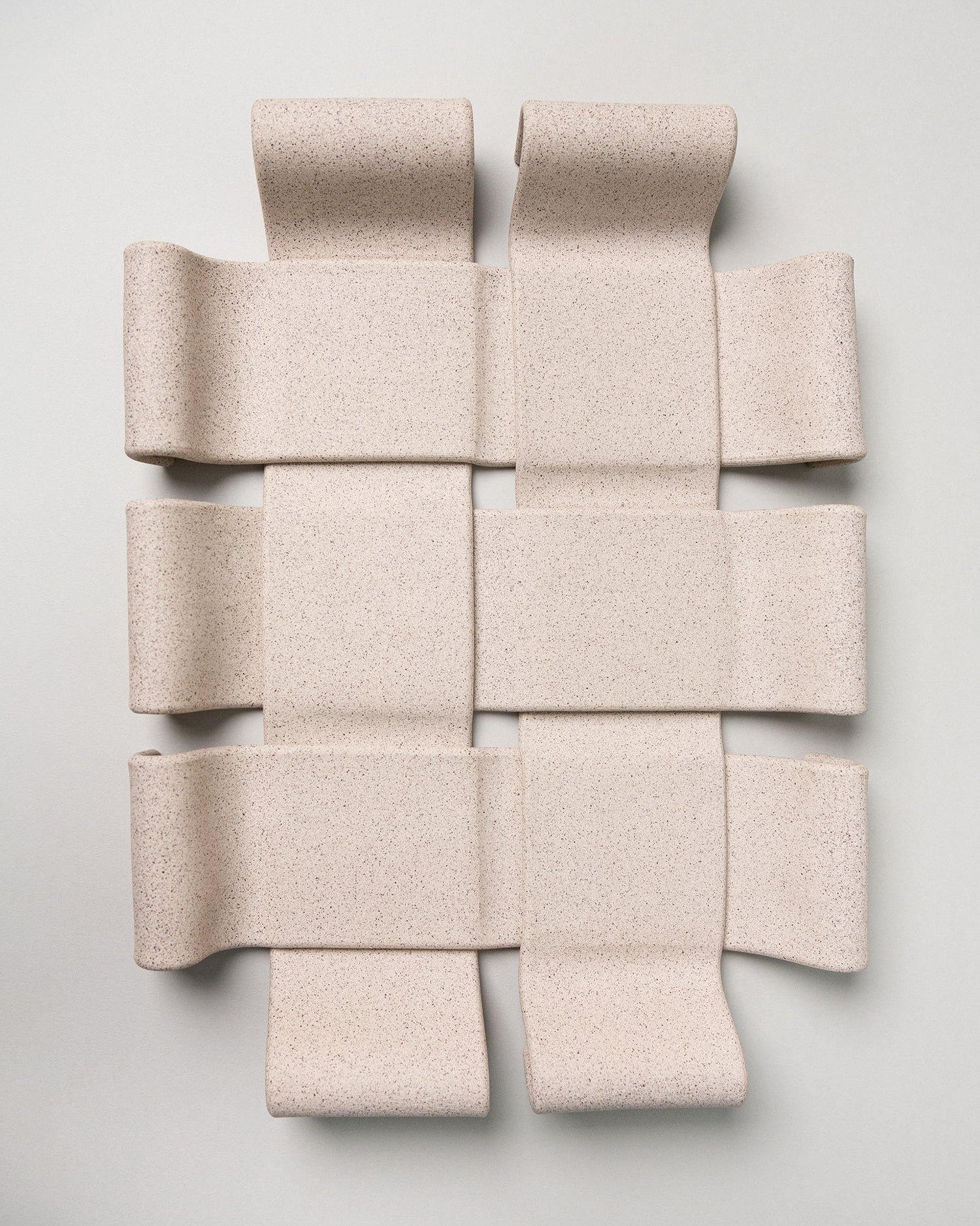 Beige woven acoustic panel on a light gray background