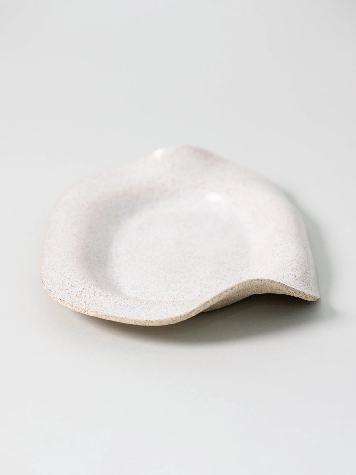 White ceramic bowl on a light gray background
